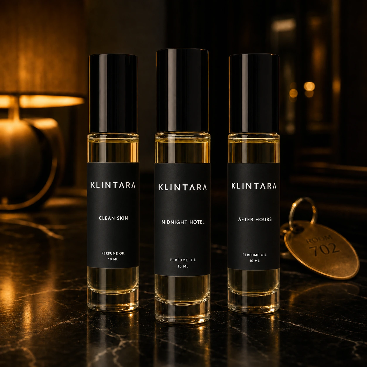 Black-label Klintara perfume-oil collection on a dark hotel vanity